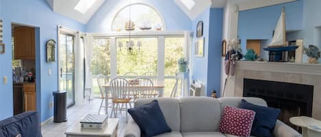 Living/dining room with view of 9th hole. Skylights. So bright and attractive.
