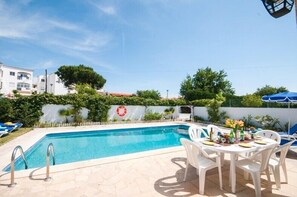 Outside dining area beside the pool and BBQ