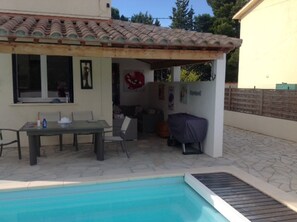 Poolside dining and shaded seating area