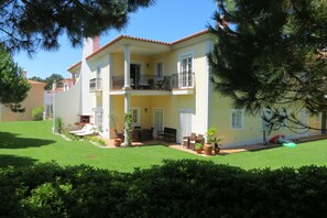 Casa Pinha surrounded by lush gardens and well kept lawn in the back