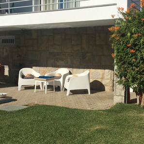 Exclusive screened porch with chairs for relaxing