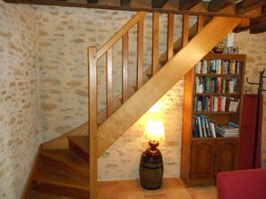 Staircase from lounge and well stocked book case