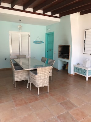 front door with covered patio table for eating el fresco dining and BBQ 