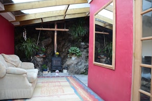 Living rock face wall with wood burner.