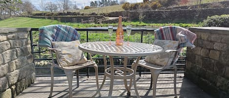 relax by stream, looking over the pond and into the wildflower meadow.