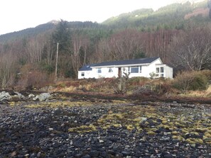 Looking up to the house from the loch .