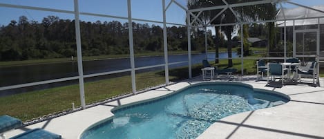 Newly resurfaced pool facing lake and conservation area