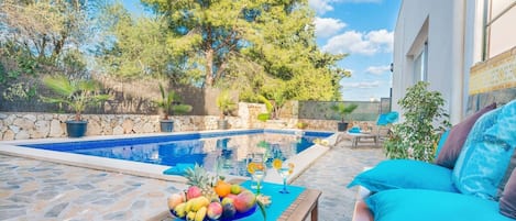 Large pool with hammocks and BBQ area