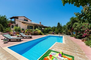 Private pool with sun beds and umbrellas