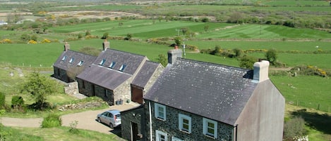 View from the Garn (rocky outcrop) of Garnllys house with two cottages nearby