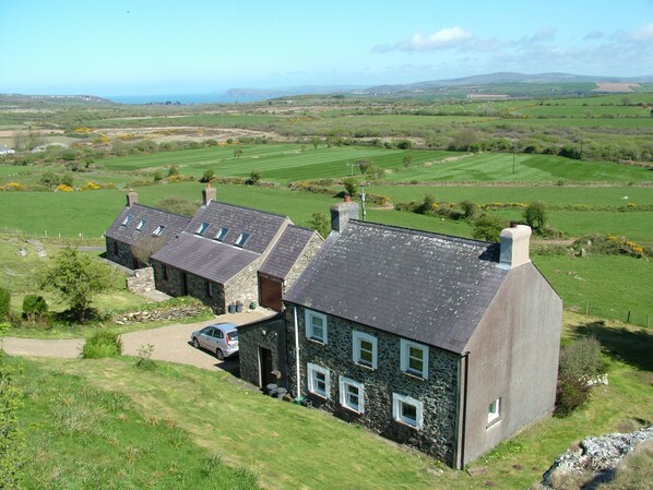 View from the Garn (rocky outcrop) of Garnllys house with two cottages nearby