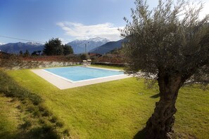 The pool is located in front of the apartment.