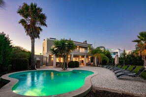 Pool and villa at night