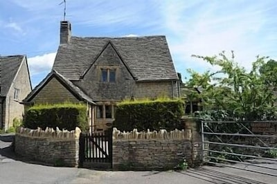 A Quaint Grade 11 Listed Detached Stone Cottage In Lower Slaughter with parking.