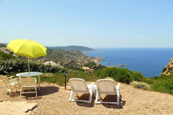 Sun loungers and sea and village view