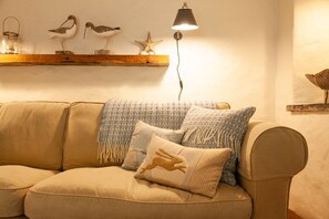 Roomy four seater sofa with bespoke furnishings with a  beautiful coastal feel.