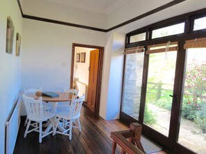 Dining Area with French Doors to a sunny terrace with table and chairs