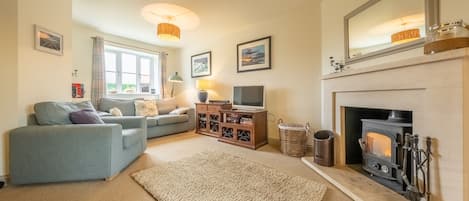 Curlew Cottage, Docking: Spacious sitting room with a wood burning stove
