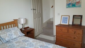 Main bedroom with stairs leading to second bedroom