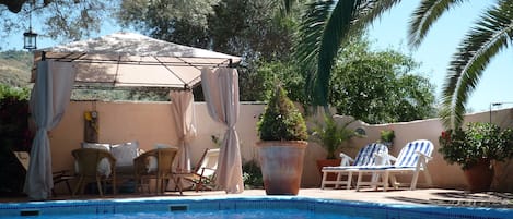 Private poolside relaxation by the walled and gated sparkling pool