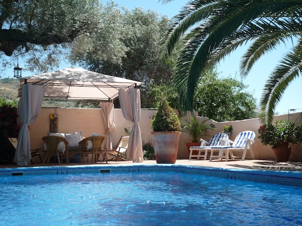 Private poolside relaxation by the walled and gated sparkling pool