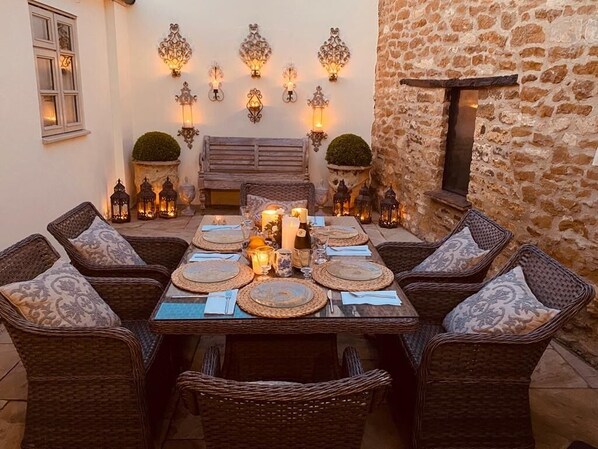 Gorgeous sunny courtyard by day and at night it almost becomes Mediterranean. 