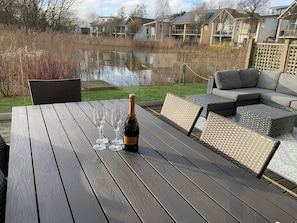 Rear decking overlooking the lake with frameless glass balustrade