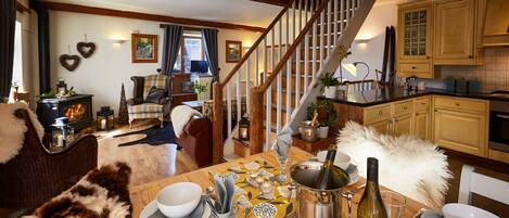 Open plan lounge, kitchen and dining area with log burning stove
