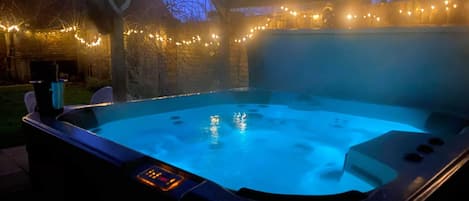 Outside enormous high quality hot tub , colour changing 