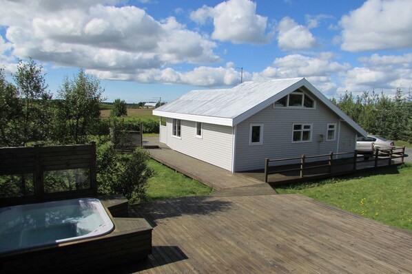 Back of house, hot tub and part of deck