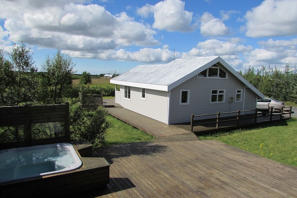 Back of house, hot tub and part of deck