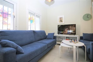 Seating for five guests by the smart TV