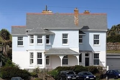 Pendragon House Overlooks Crooklets Beach in Bude with parking for 5 cars.