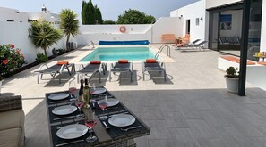 Relax and alfresco dine on super comfy sofas/dining table under covered pergola.