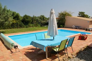 A view of the pool and the rear patio