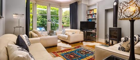 The main sitting room with huge sofas and log burner