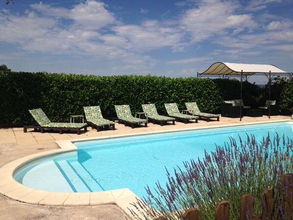 Heated pool with roman steps and shaded seating