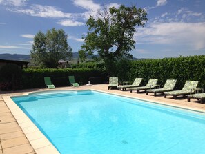 Heated pool sheltered by laurel hedge