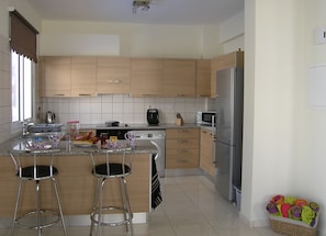 Open plan kitchen with breakfast bar.