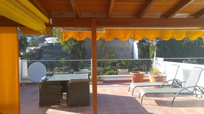The private roof terrace with shaded area and cold shower
