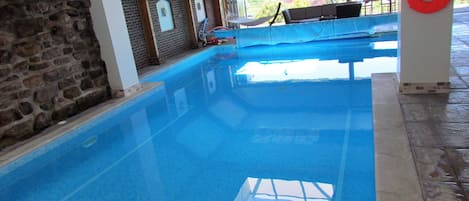 Private heated indoor swimming pool 12m x 7m accessed from lounge 1m to 2m depth