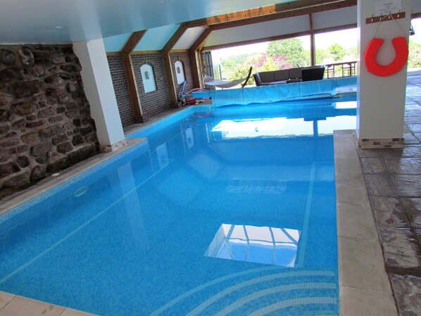 Private heated indoor swimming pool 12m x 7m accessed from lounge 1m to 2m depth