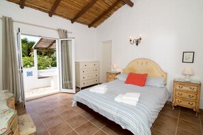 Main en-suite bedroom with doors leading to terrace