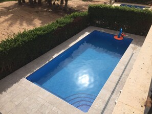 Private pool with seated area to cool off in the summer months or heat in winter