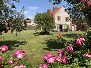 2 Dix Cottages, Thornham: Front gable end elevation and garden