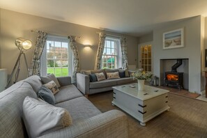 2 Dix Cottages, Thornham: Sitting room with wood burning stove