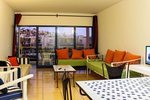 Living room with two single sofa beds and Living room with two single sofa beds and TV with access to balcony 