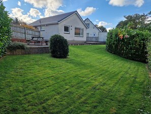 large garden with two patio areas
