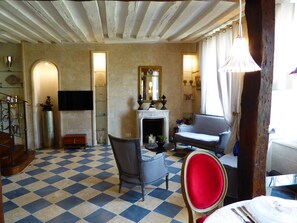 View from dining room towards living, beams sandstone walls, fireplace 1607 AD