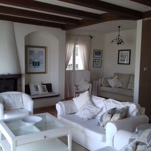 Open Sitting room with fireplace for the  winter and air conditioning.